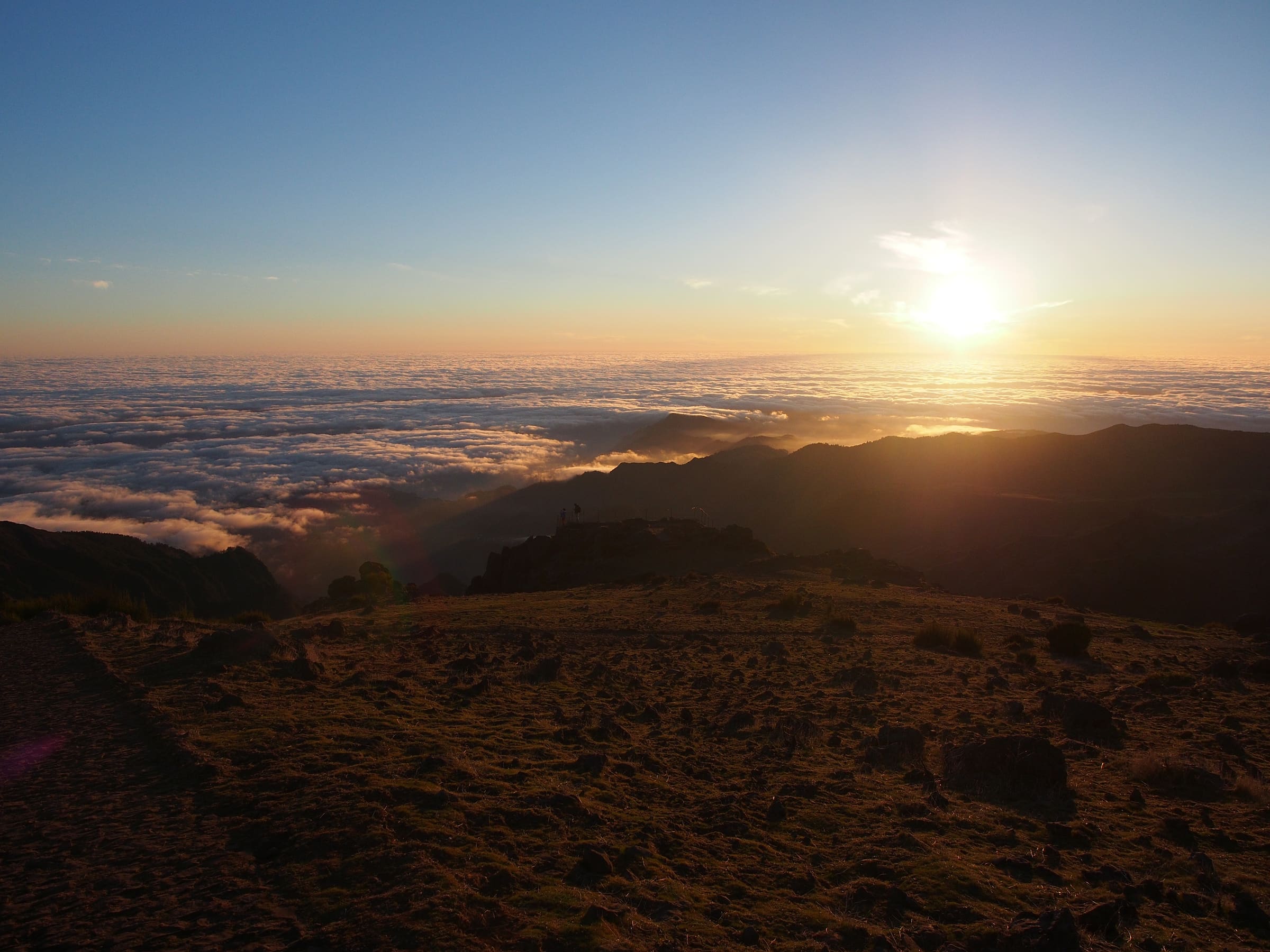 Sunrise above a sea of clouds seen from the summit of Pico do Arieiro, Madeira.